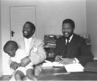 Oliver Tambo, with a child and Nelson Mandela