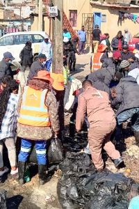 Volunteers from RebuildSA clean up after looting in Soweto, July 2021