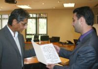 A delegation of Syrian students presents gifts to Nelson Mandela Foundation CE Achmat Dangor