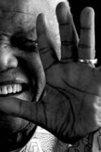 Nelson Mandela, with hand raised in front of his face (small image)