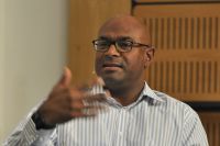Kuben Naidoo participates in a p[anel discussion with Thomas Pickety