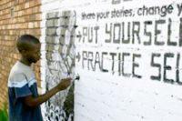 Artist painting a HIV/Aids mural. 2007