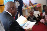 President Reading To The Children Of Little Flower Ecd Centre